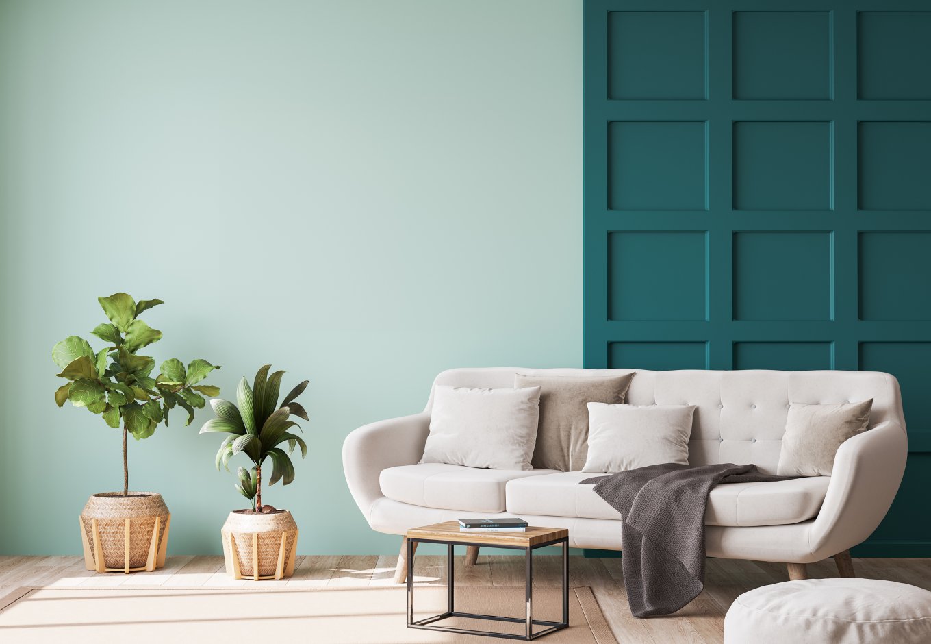 Moderne stue med grønn vegg, hvit sofa, planter og et lite bord.