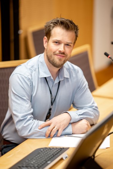 Mann i skjorte ved sin pc