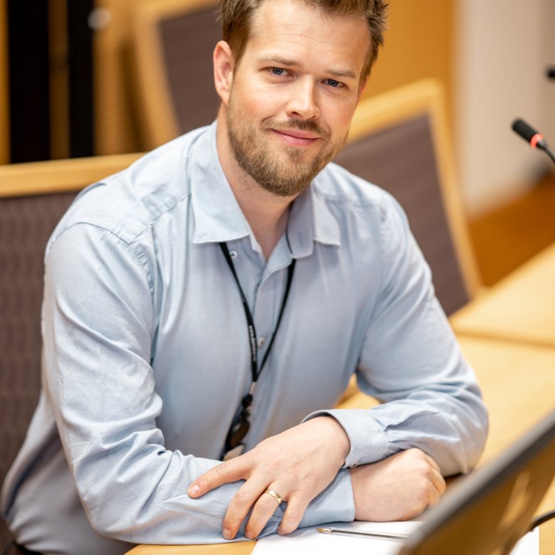 Mann i skjorte ved sin pc