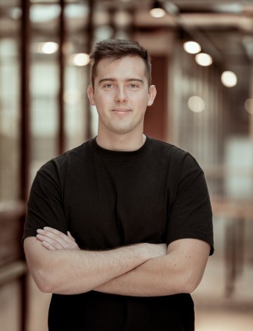 Mann i sort tskjorte foran kamera