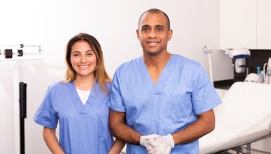 Bilde av en kvinne og mann i uniform som jobber som tannlegeassistenter